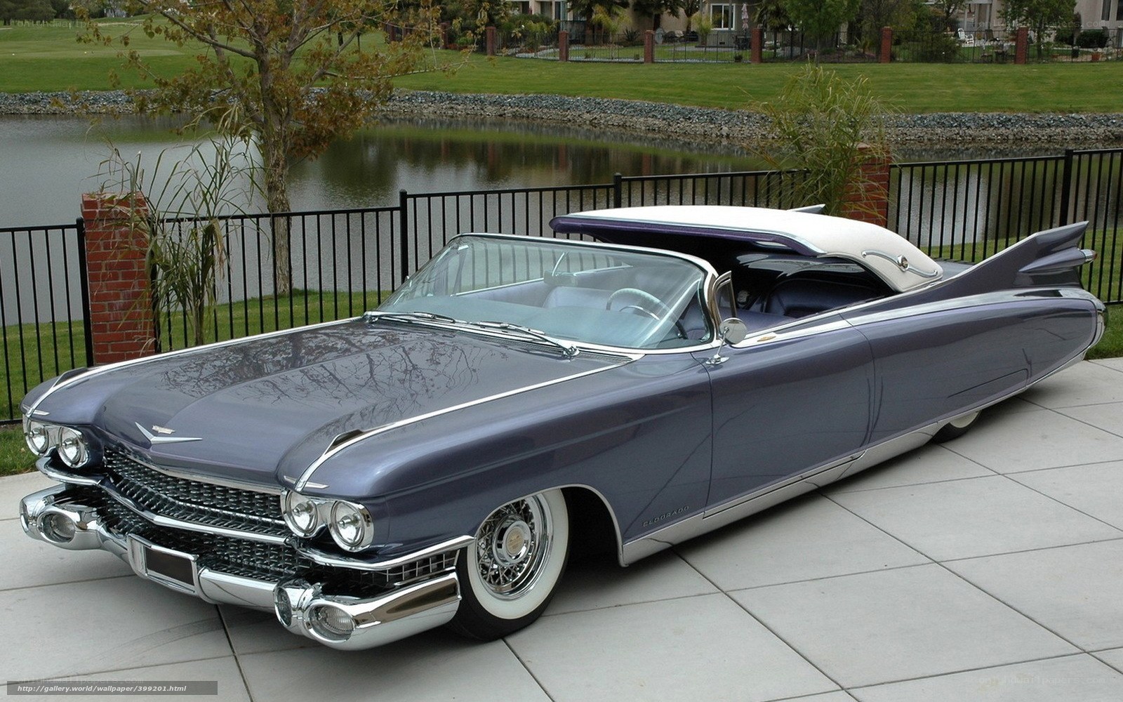 Classic Cadillac convertible by a pond