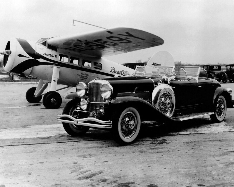 Classic car and airplane at airfield