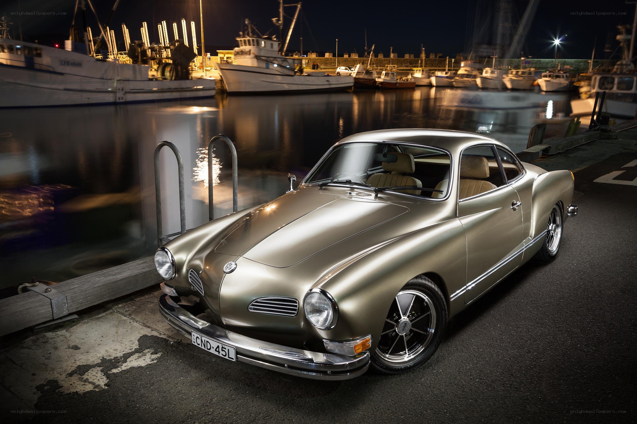 Classic car at a nighttime harbor