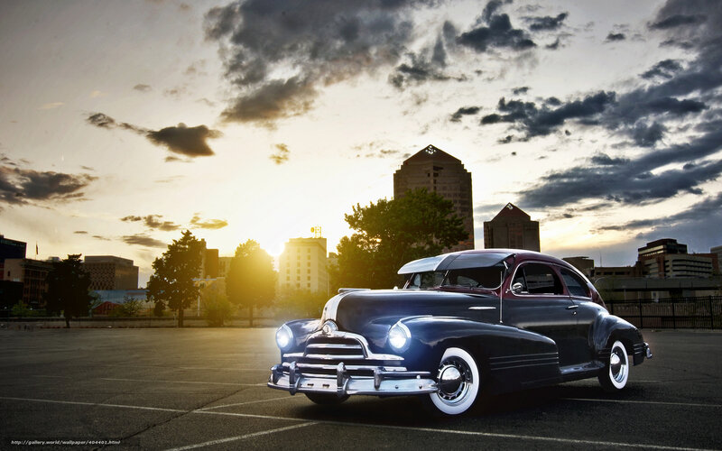 Classic car at sunset in city
