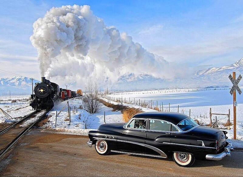 classic car at train crossing