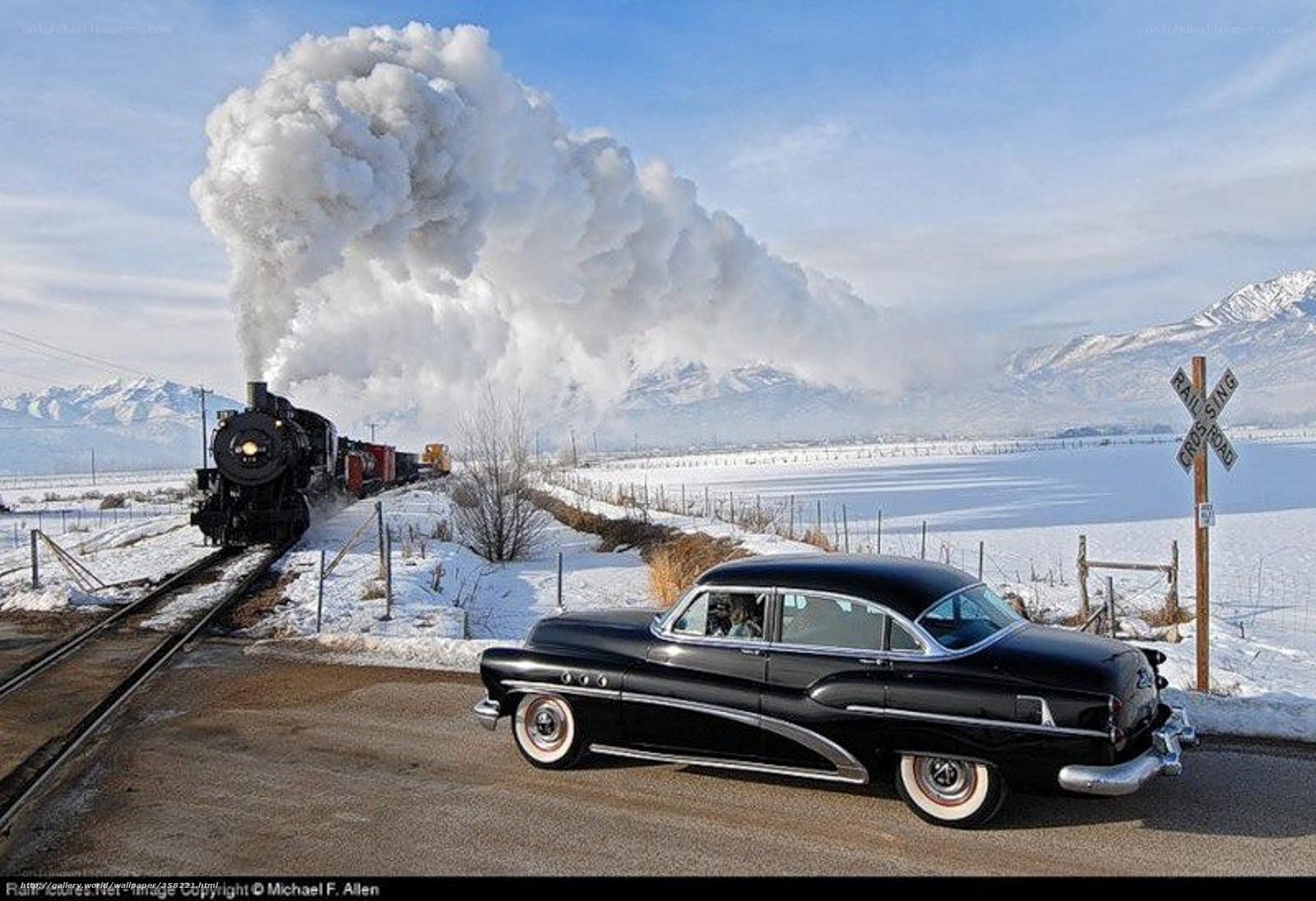Classic car at train crossing