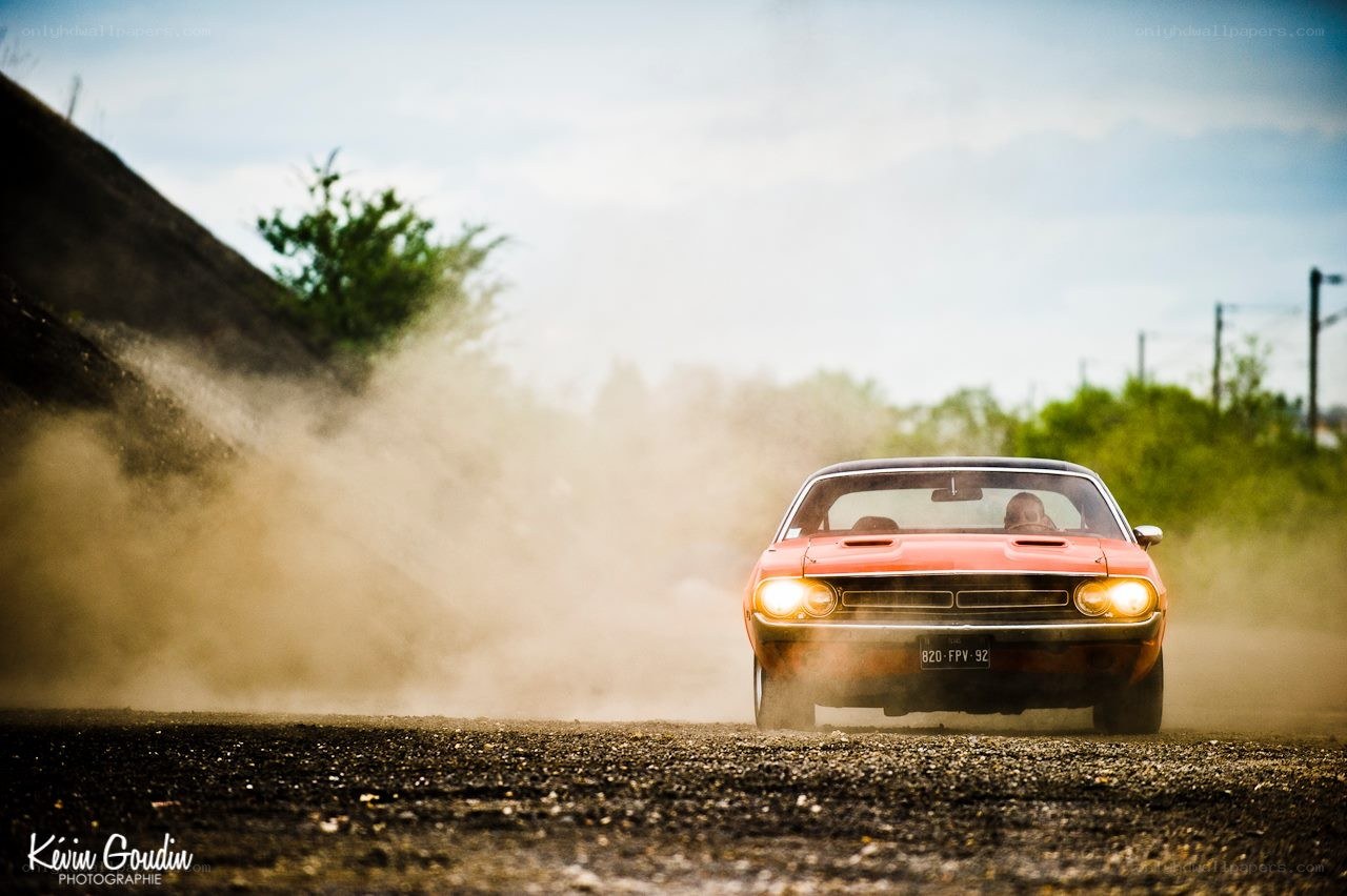 Classic car drifting on dirt road
