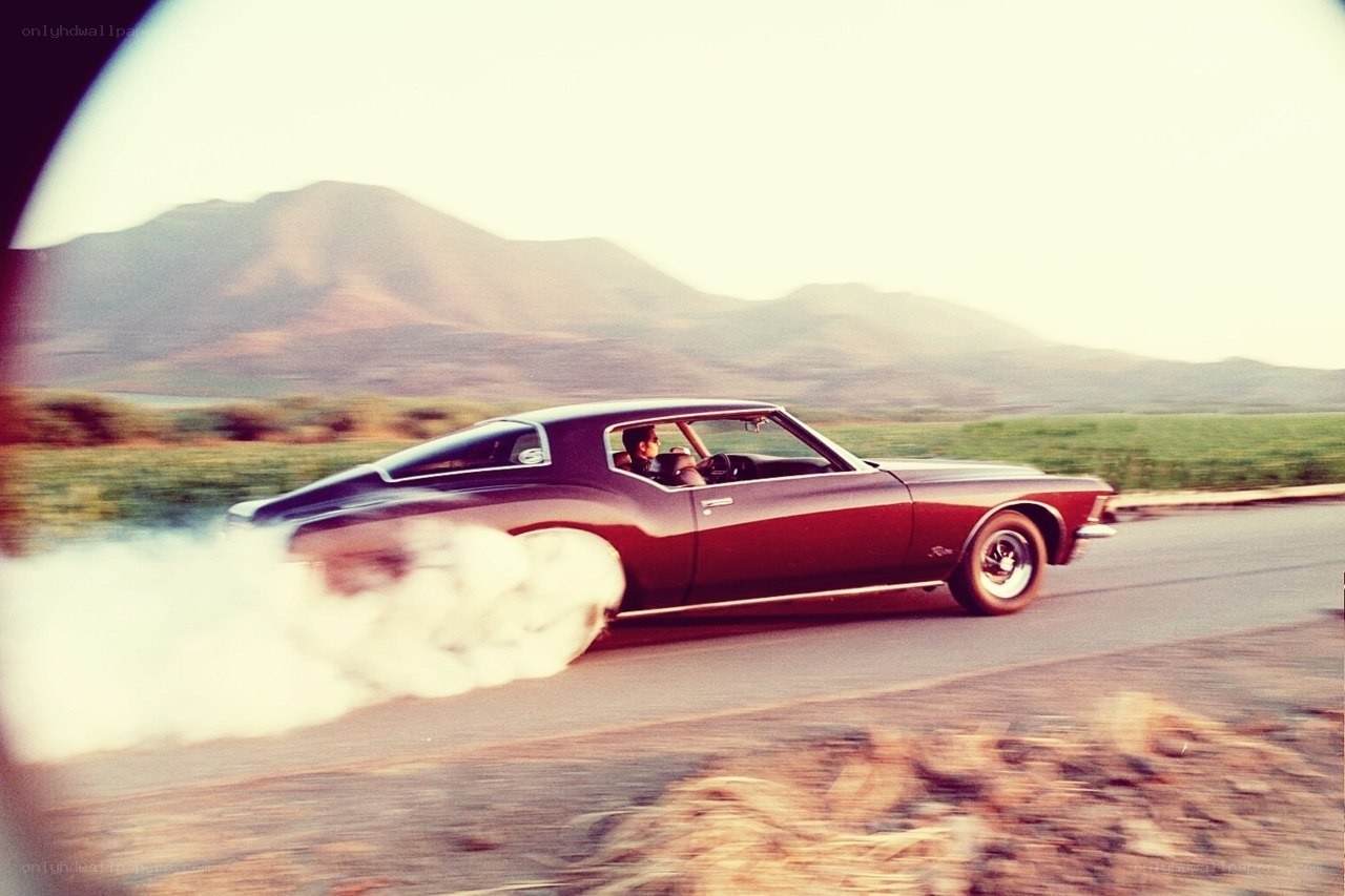 Classic car drifting on road