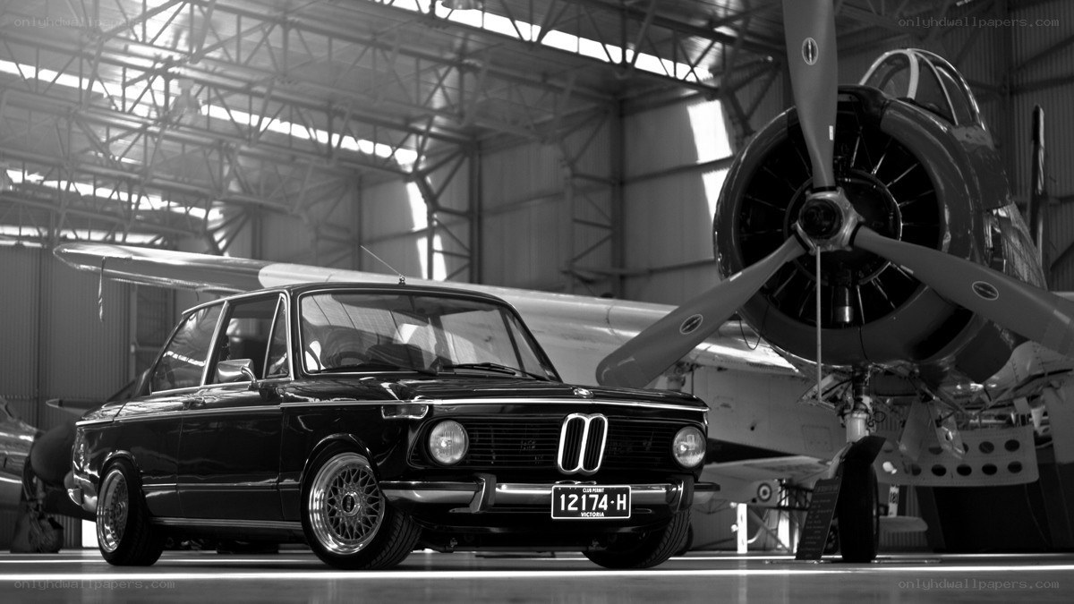 Classic car in aircraft hangar
