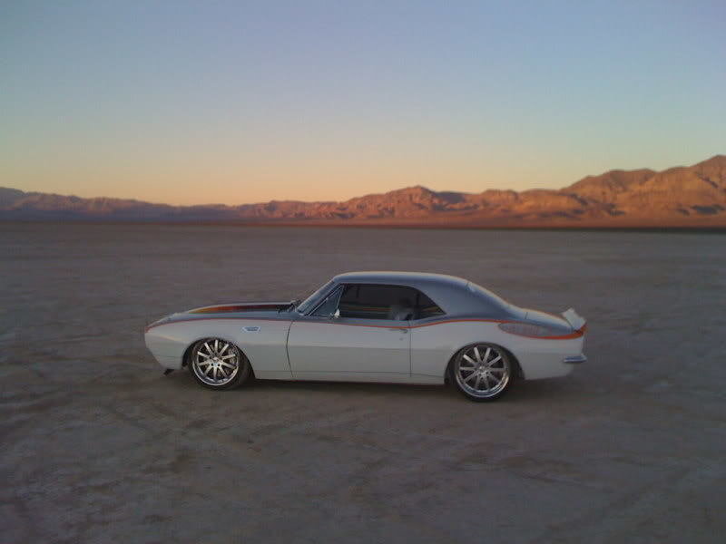 Classic car in desert at sunset