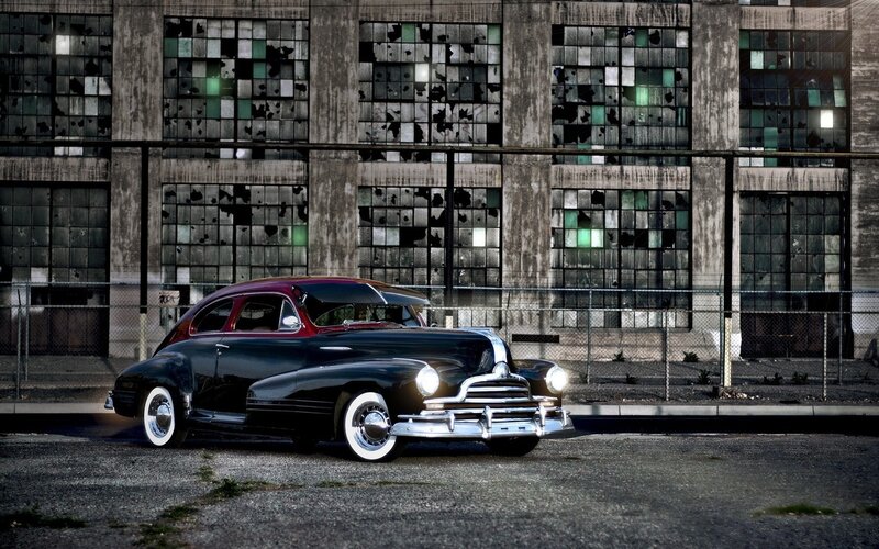 Classic car in front of a warehouse