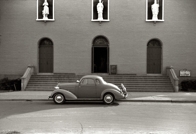 Classic car in front of cathedral
