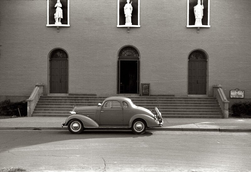Classic car in front of cathedral