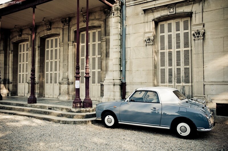 Classic car in front of old building