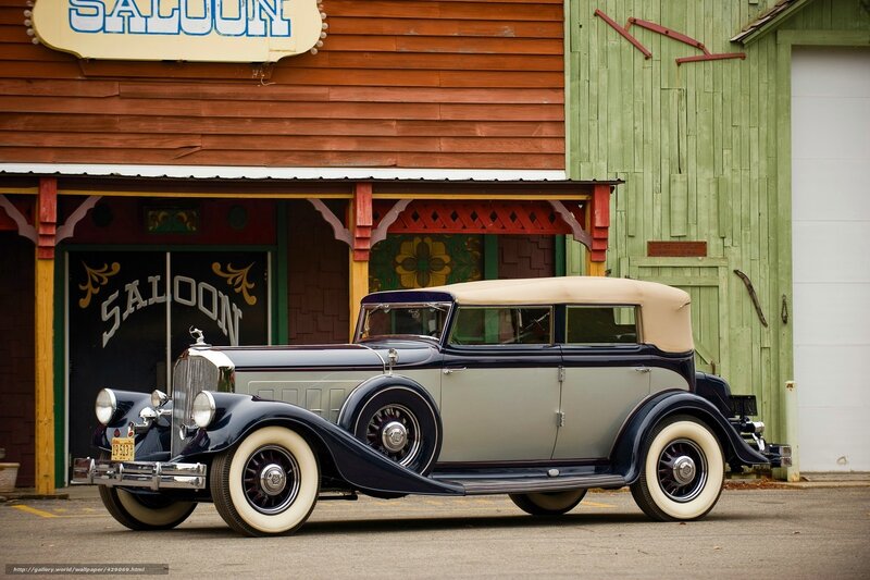 Classic car in front of saloon