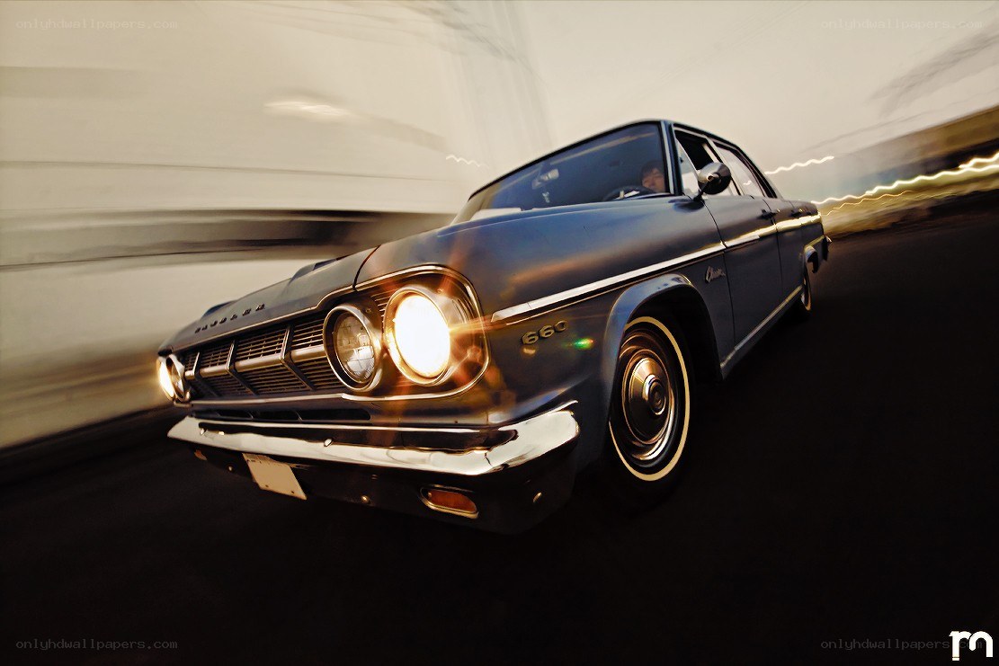 Classic car in motion at dusk
