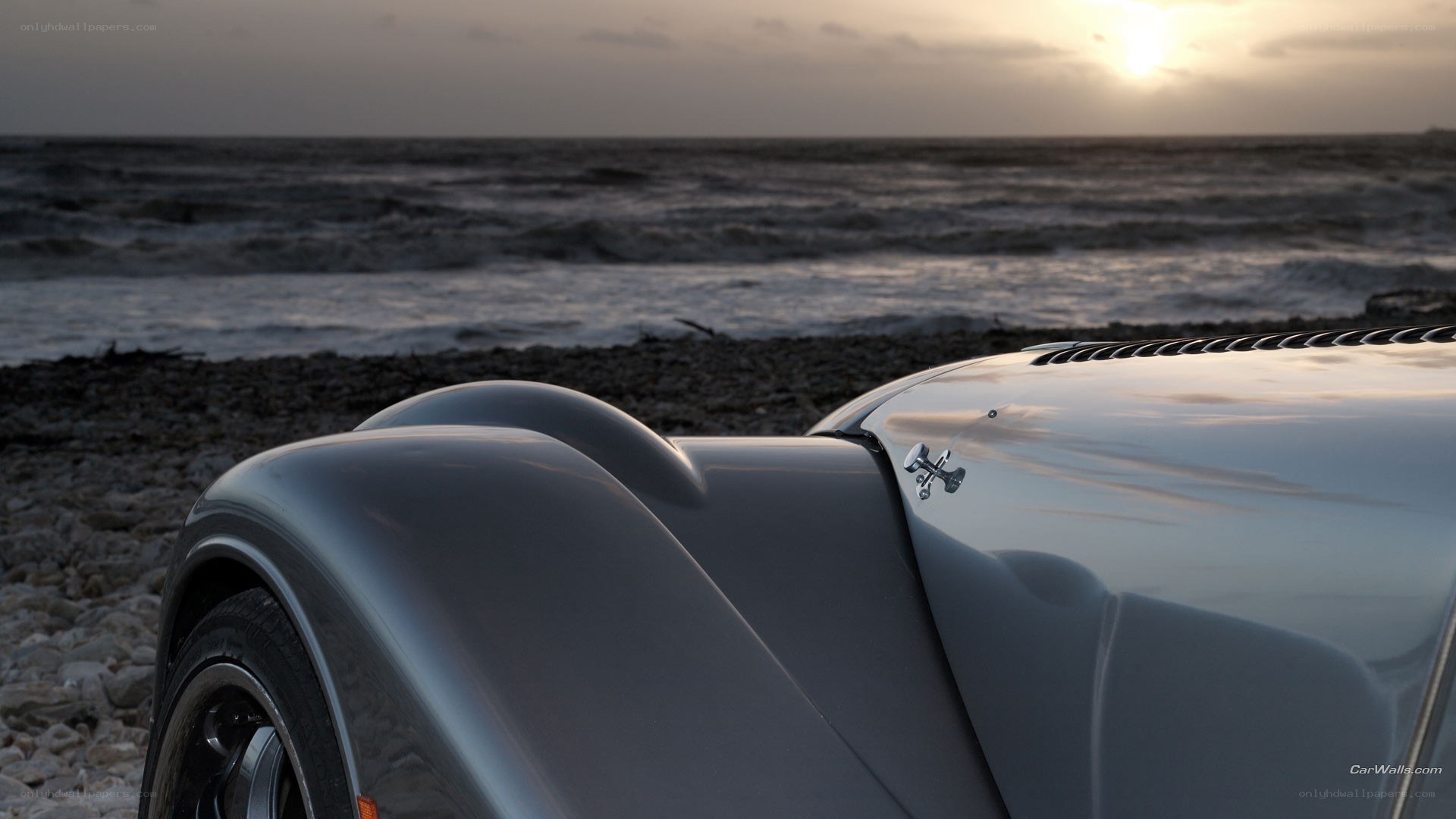 Classic car on a pebble beach