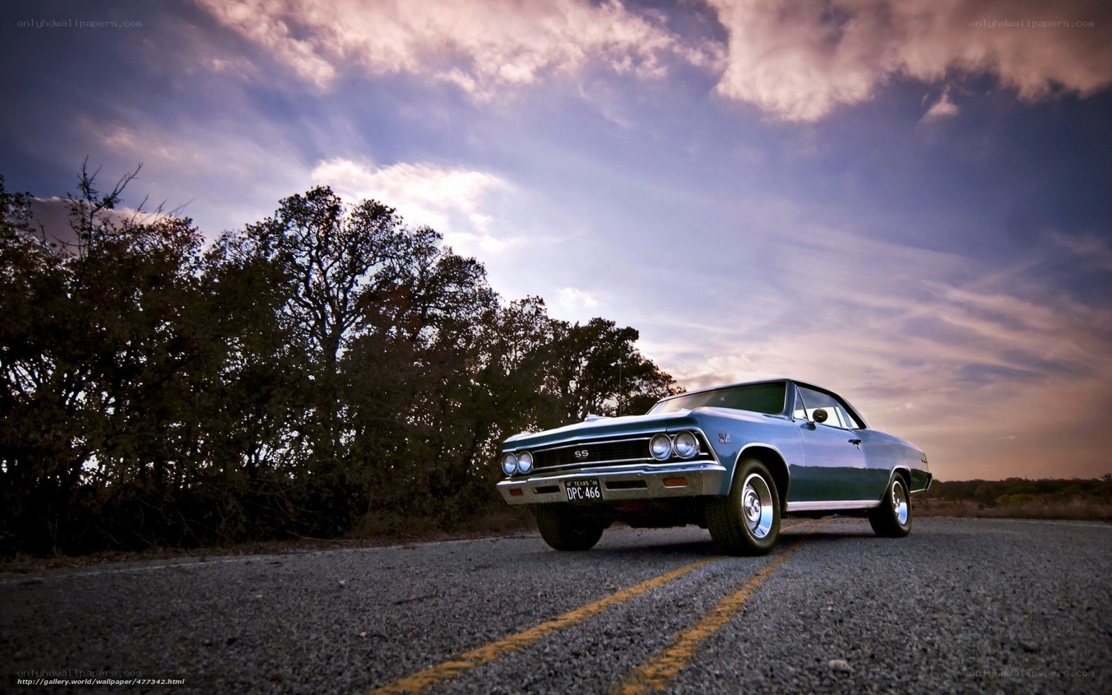 Classic car on a road at sunset