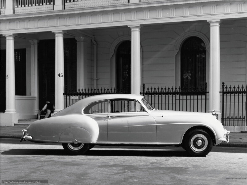 Classic car parked in front of building