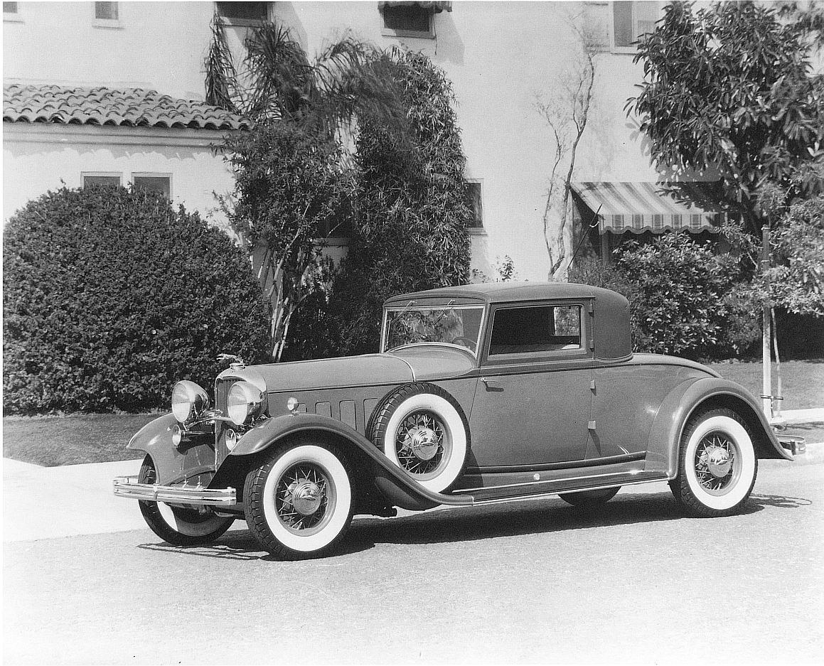 Classic car parked outside house