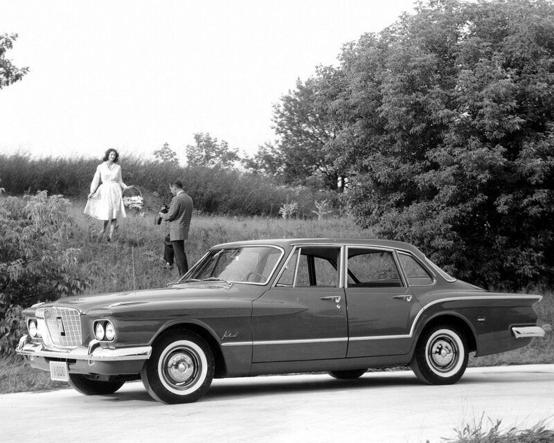 Classic car with couple in field