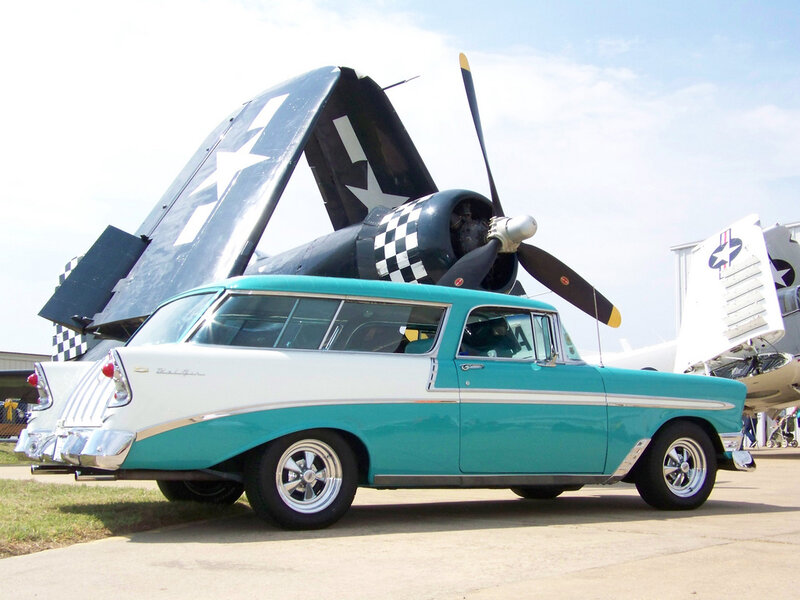 Classic car with warplane in background