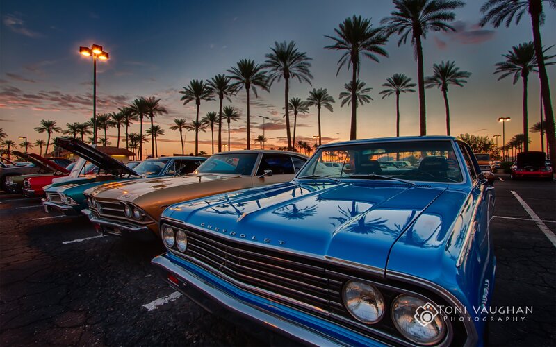 Classic cars at sunset with palm trees