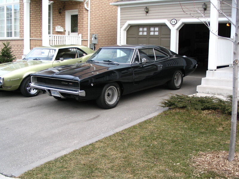 Classic cars in driveway