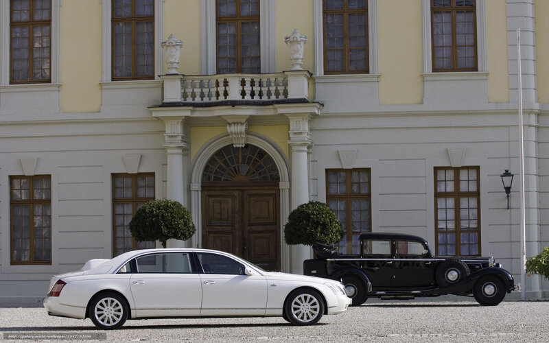 Classic cars in front of a mansion