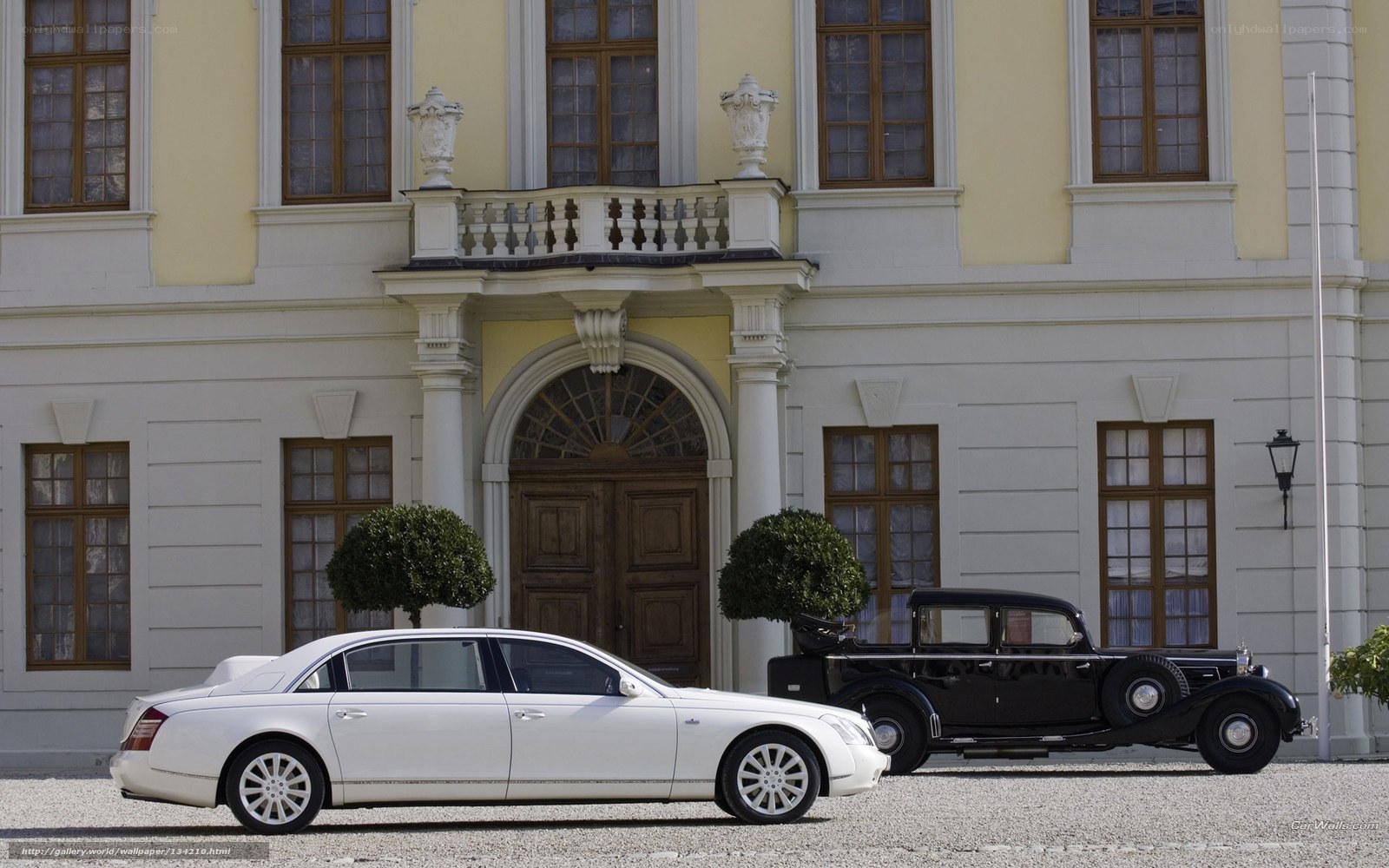 Classic cars in front of a mansion