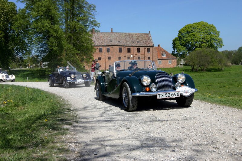 Classic cars on a gravel road