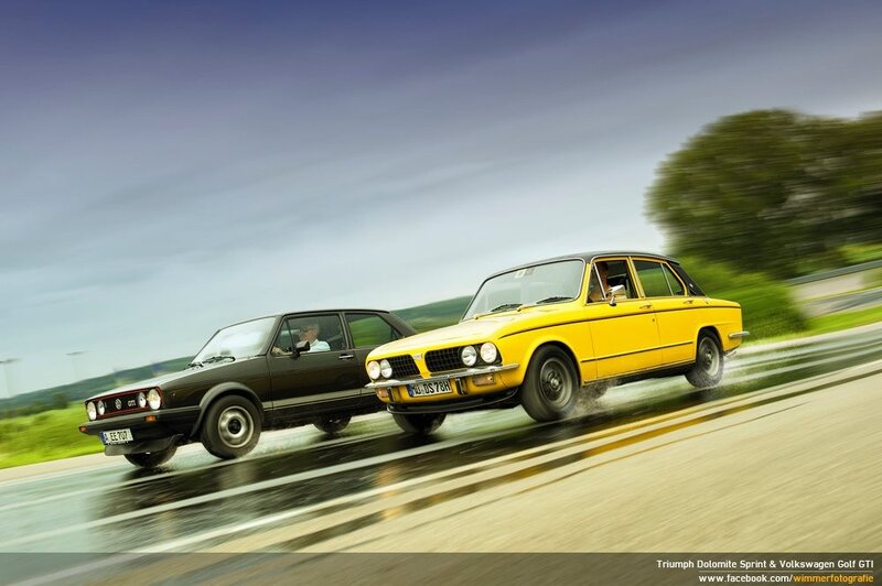 Classic cars racing on wet road