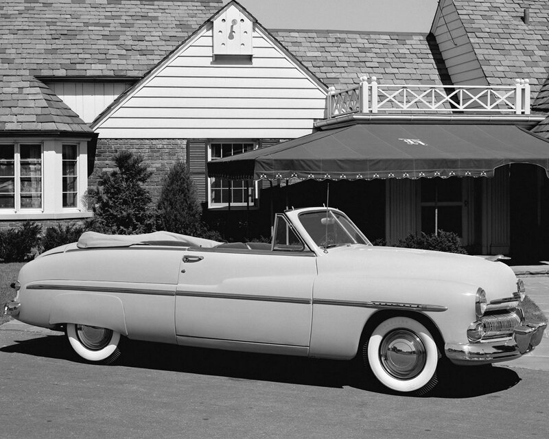 Classic convertible car in front of house