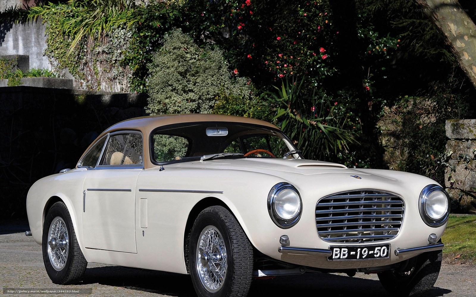 Classic cream car in garden