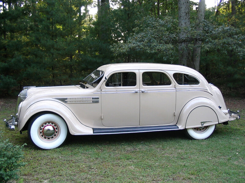 Classic cream-colored car in forest