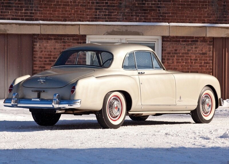 Classic cream-colored car in snow