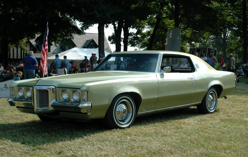 Classic gold car at outdoor show