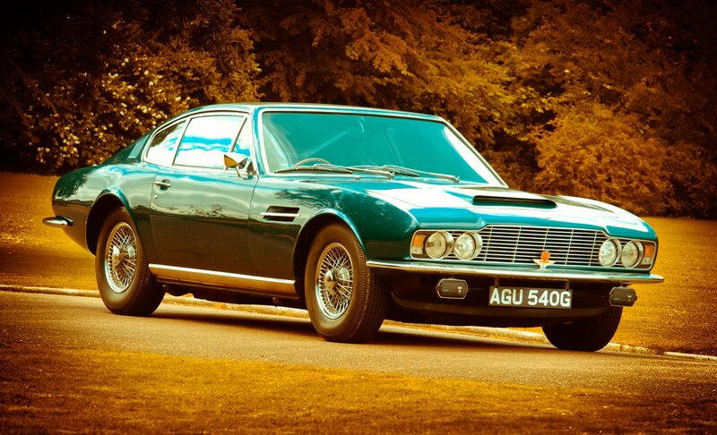 Classic green Aston Martin on road
