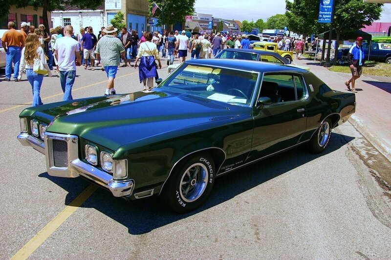 Classic green car at a street fair