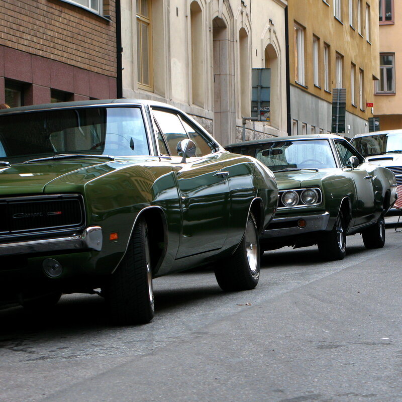 Classic green muscle cars on street
