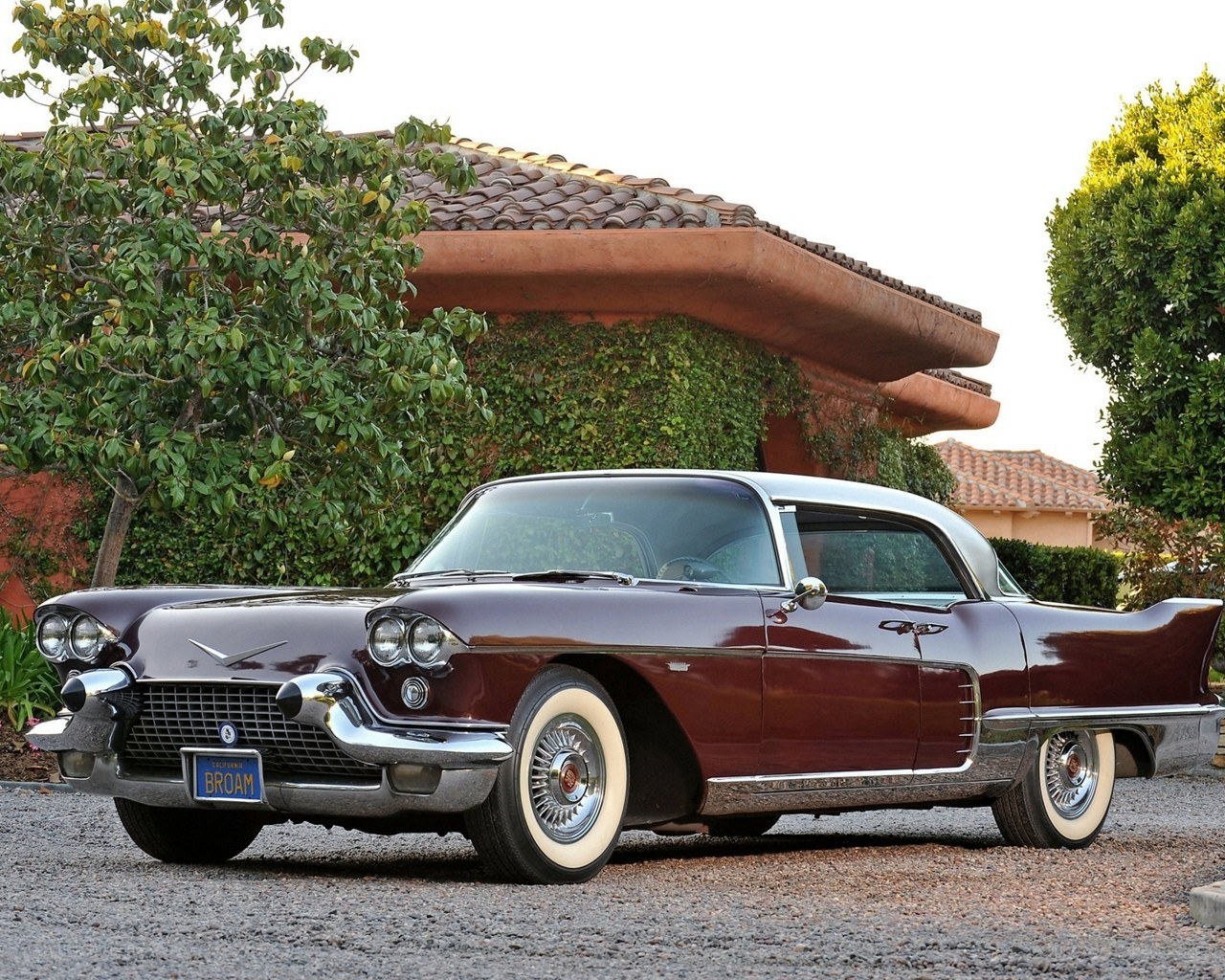 Classic maroon Cadillac parked outside
