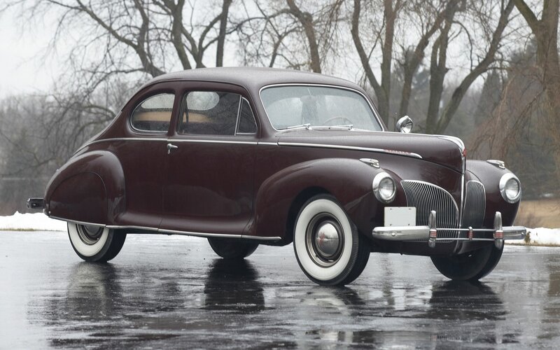 Classic maroon car on wet pavement