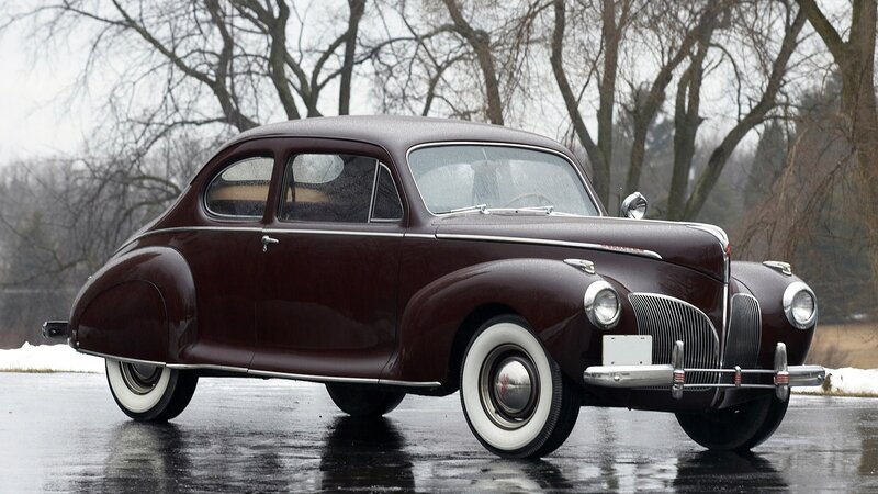 Classic maroon car on wet pavement