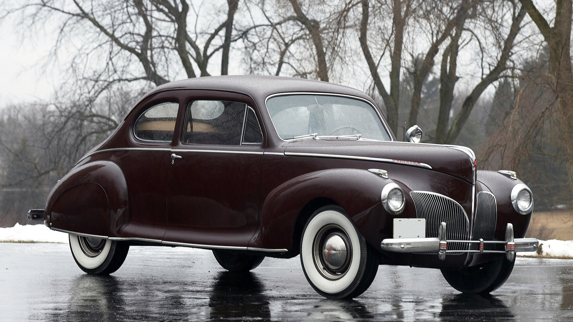 Classic maroon car on wet pavement