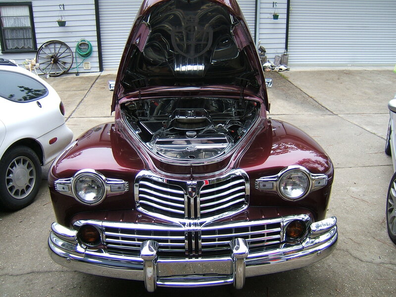 classic maroon car with open hood
