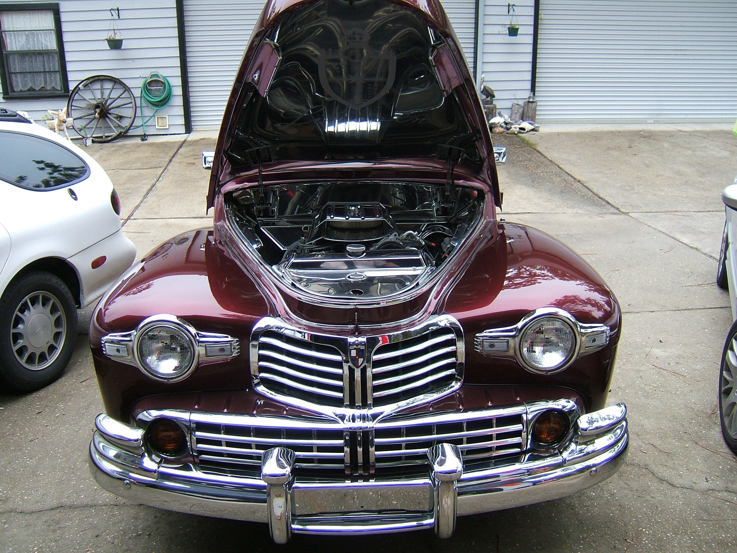 classic maroon car with open hood