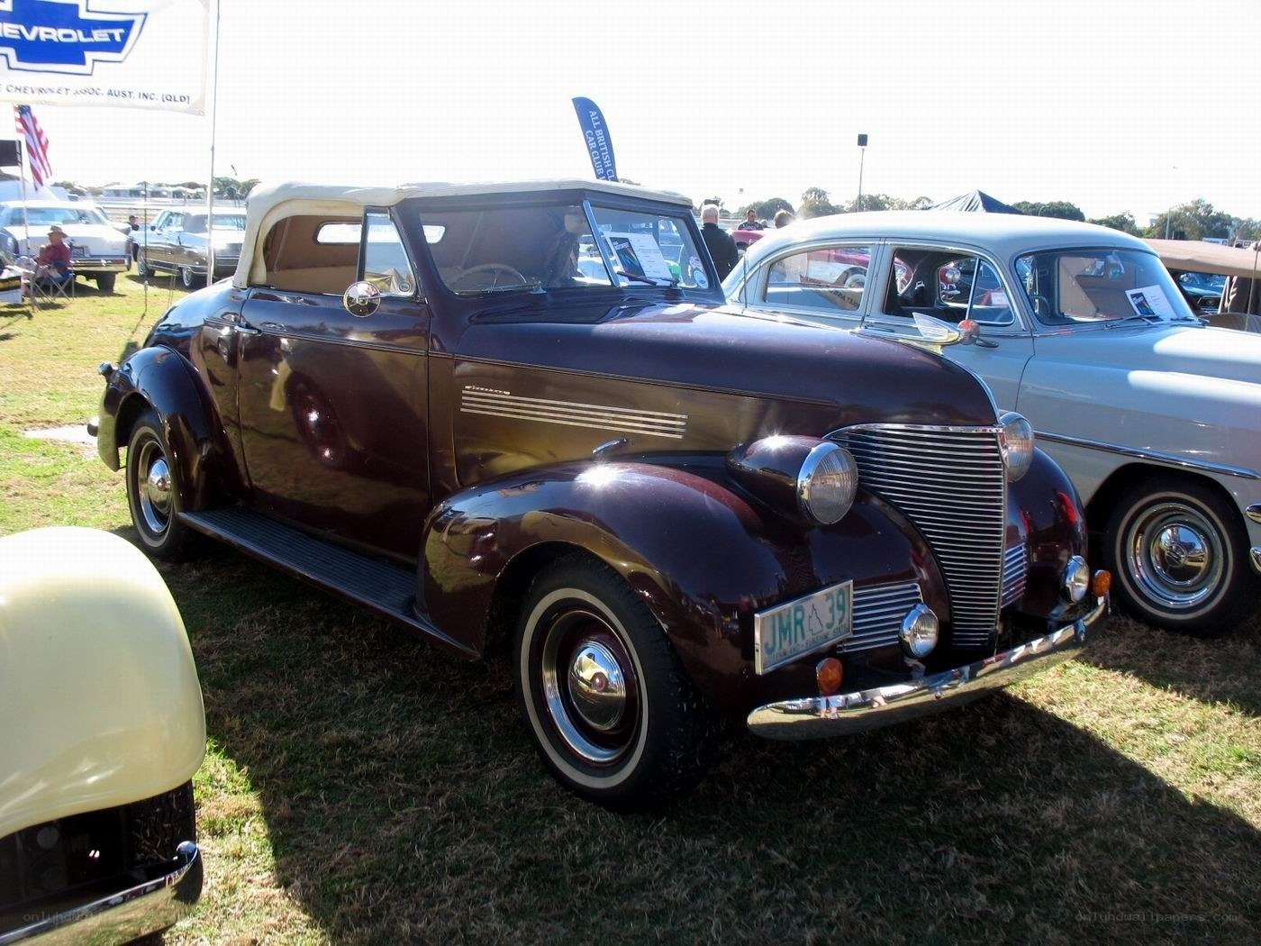 Classic maroon convertible at car show