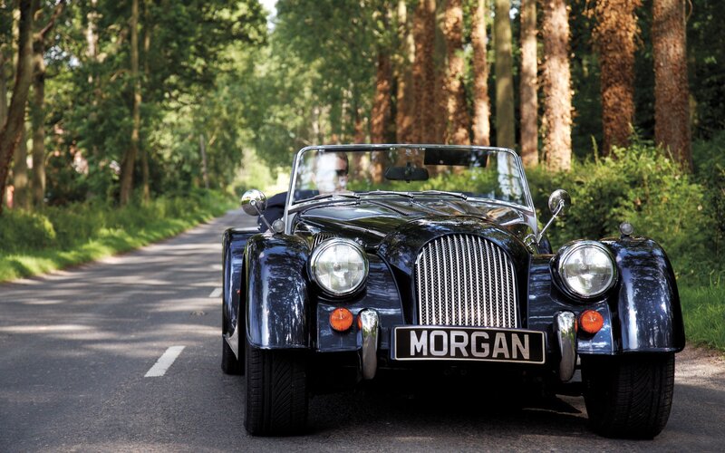 Classic Morgan car on a forest road