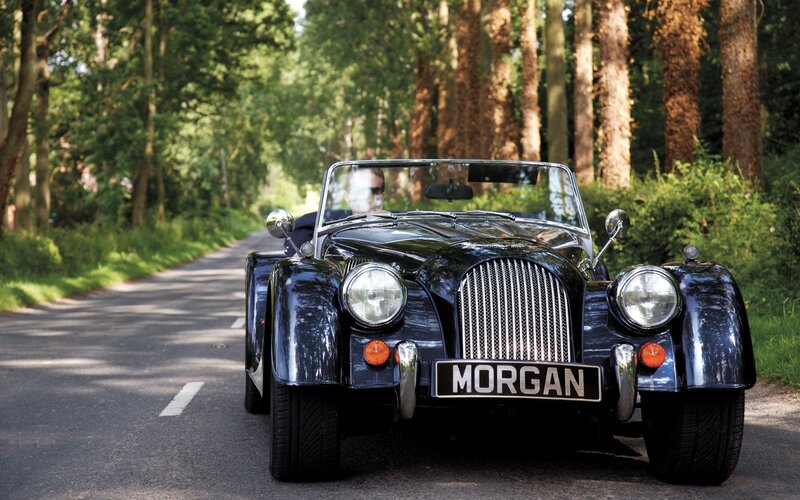 Classic Morgan car on a forest road