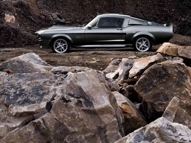Classic muscle car on rocky terrain