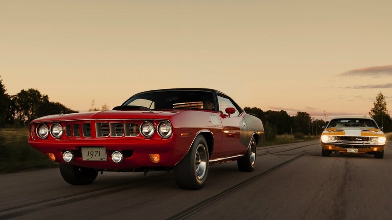 Classic muscle cars on a road
