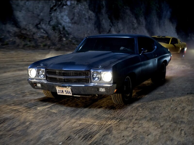 Classic muscle cars racing at night