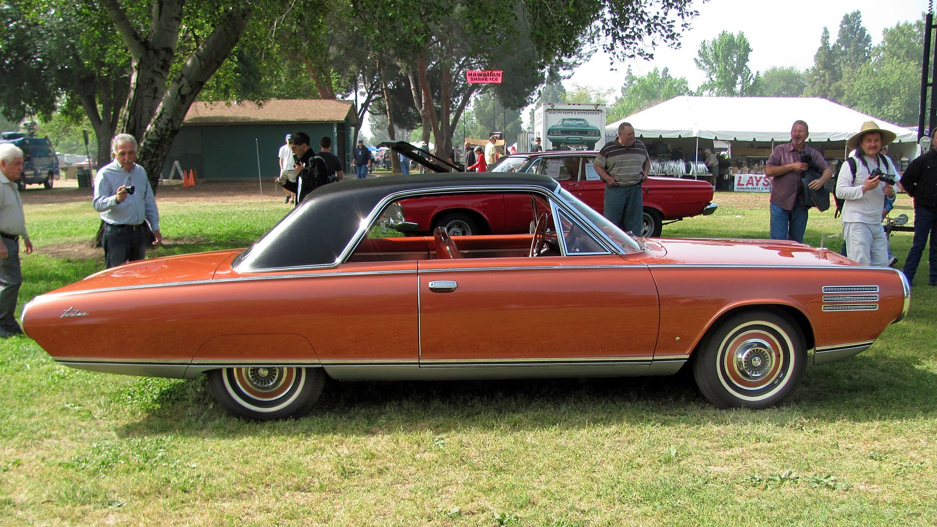 Classic orange car at outdoor show