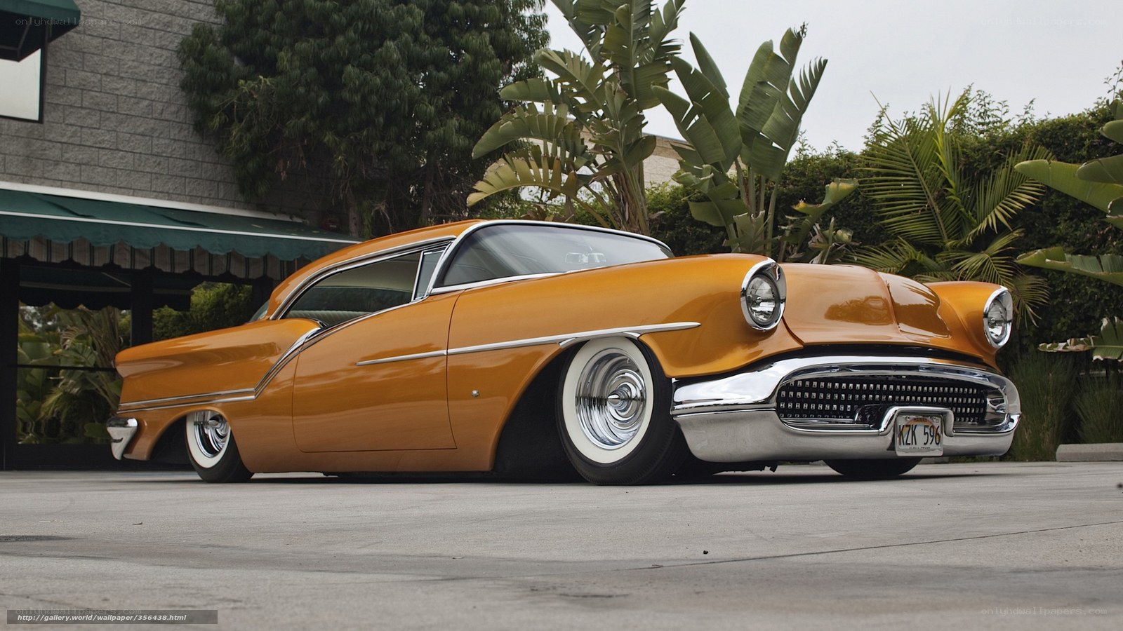 Classic orange car in driveway
